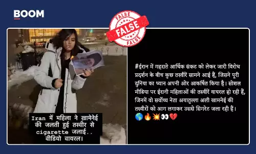 Iran woman burning Khameneis picture with a cigarette